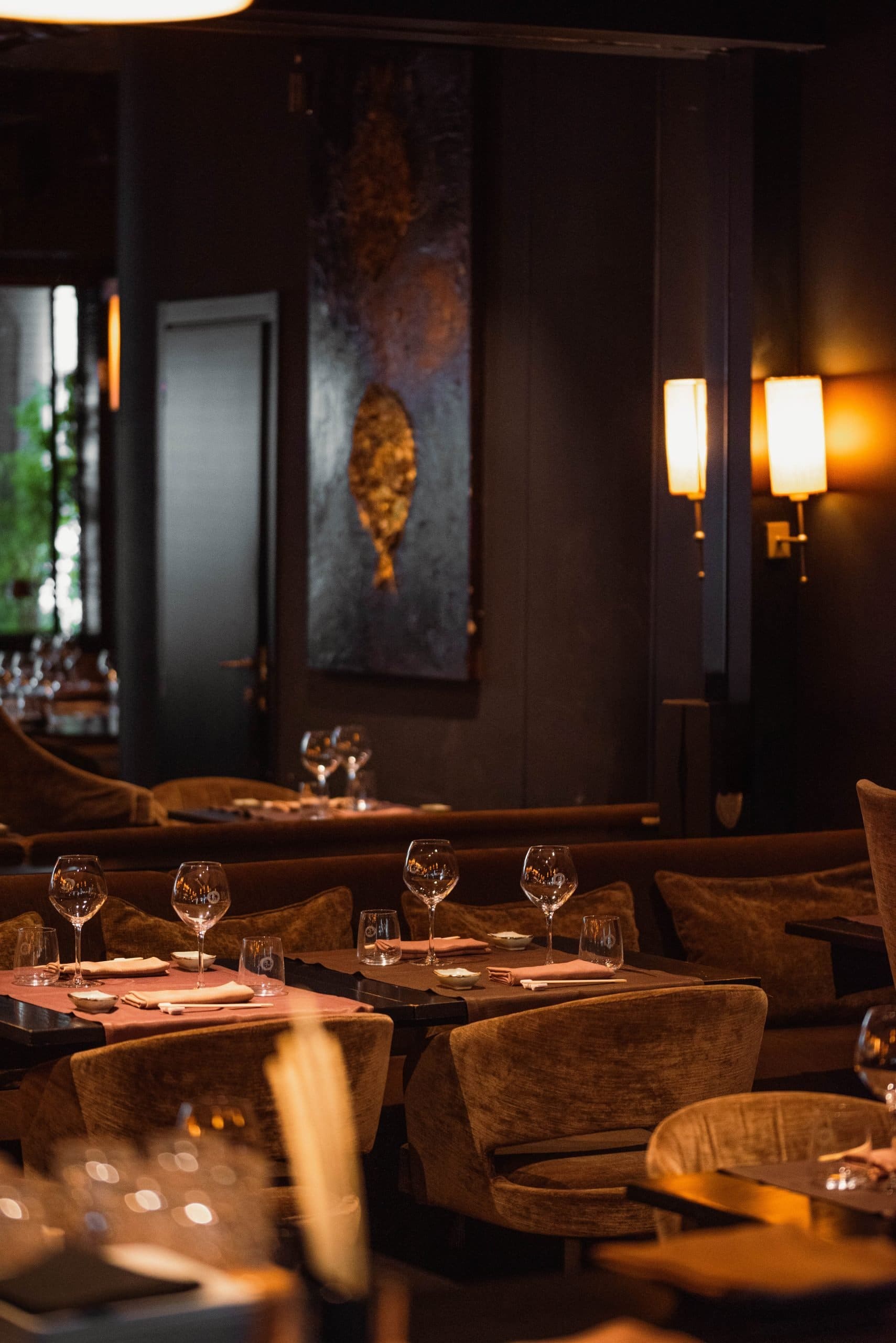 Set tables in a restaurant with soft lights.