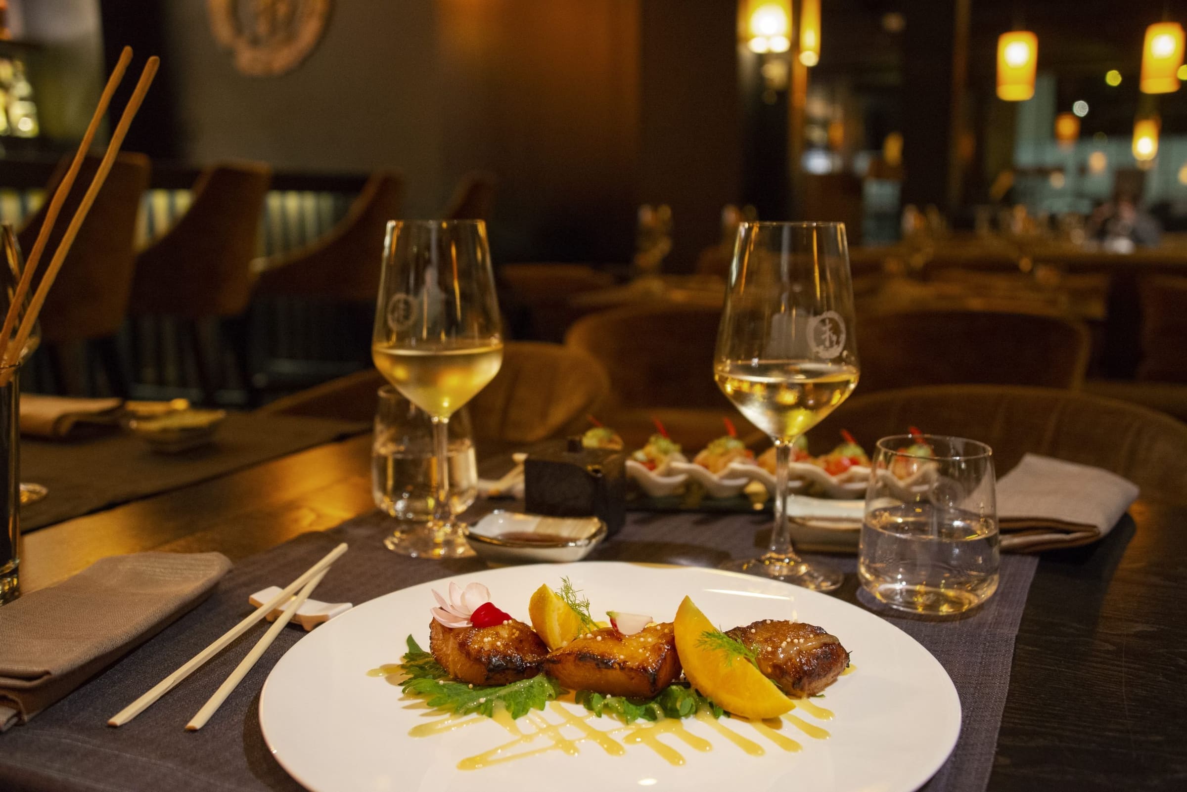 Gourmet dishes with white wine in a refined restaurant