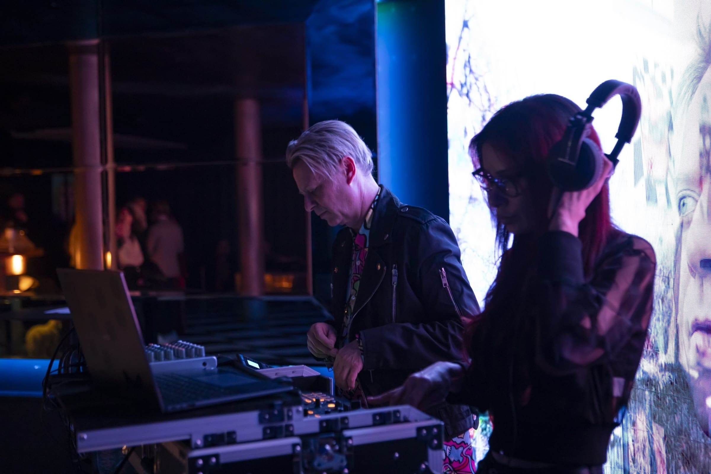 Two DJs playing at the console during an evening at the restaurant.