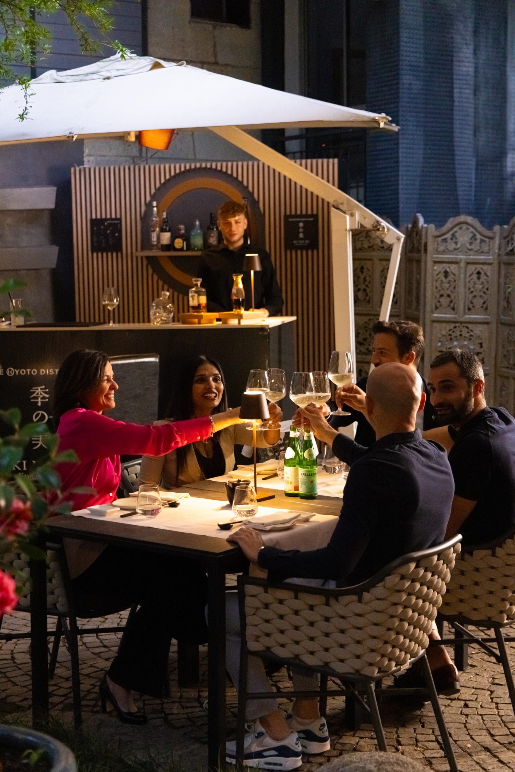 People toasting outdoors at a restaurant