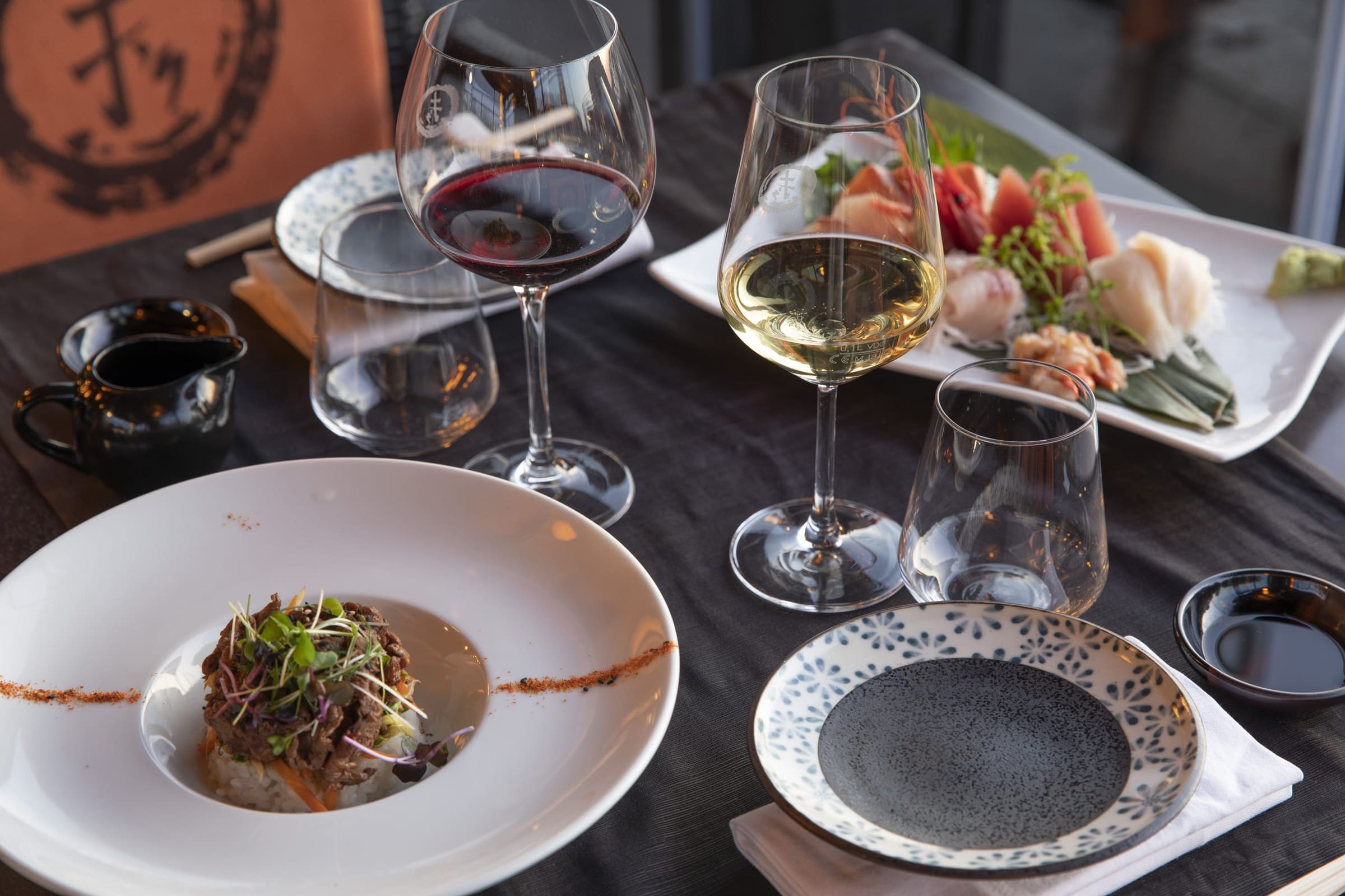 Dinner with refined dishes and glasses of wine in an elegant restaurant.